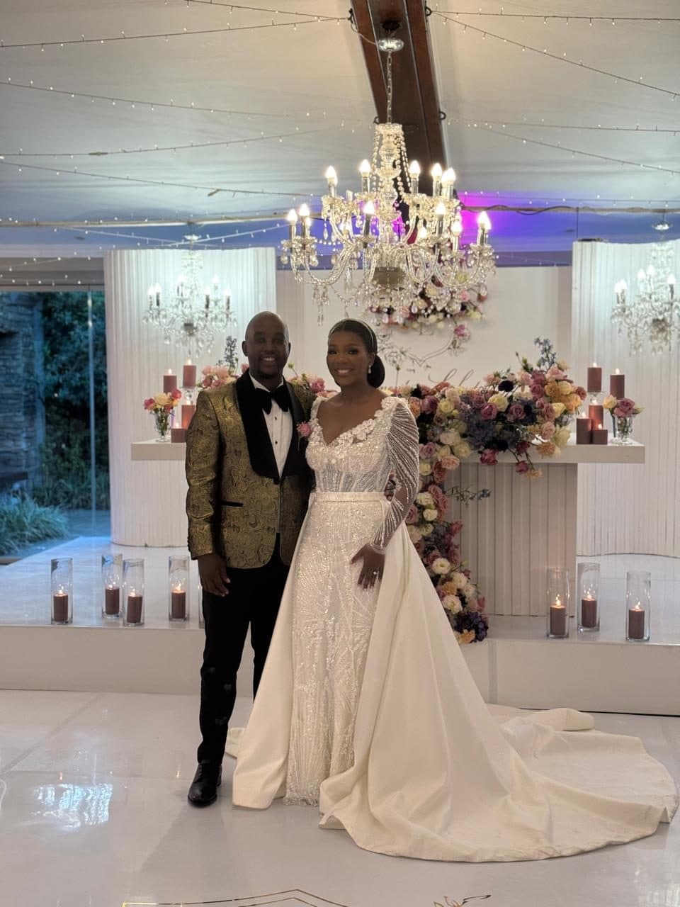 Couple celebrating their anniversary in front of the floral main table