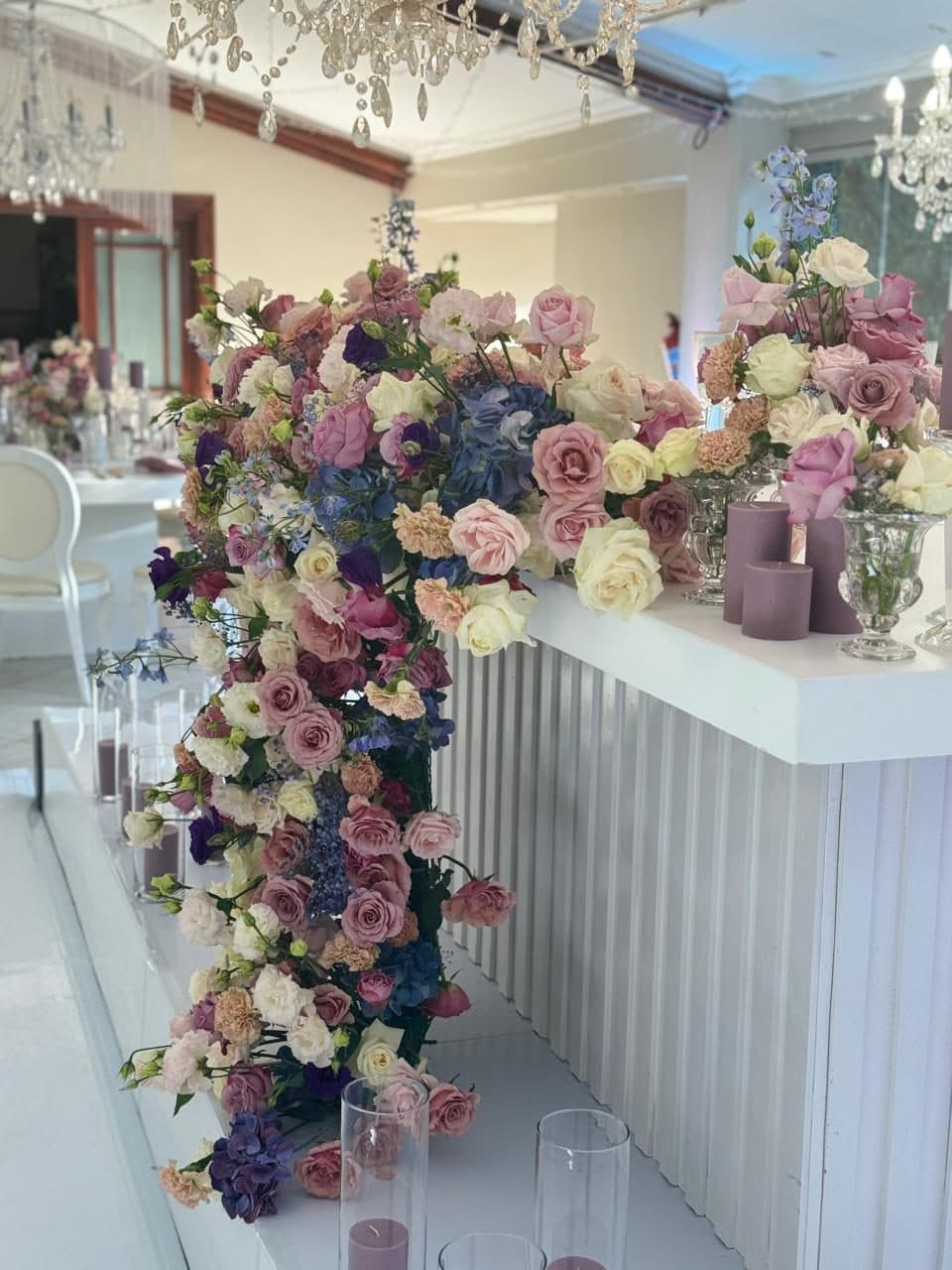 Dusky pink and blue floral cascade spilling over a fluted bar front