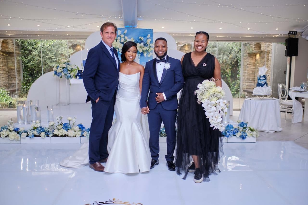 The Kuhle Events team with the bride and groom on the white dance floor