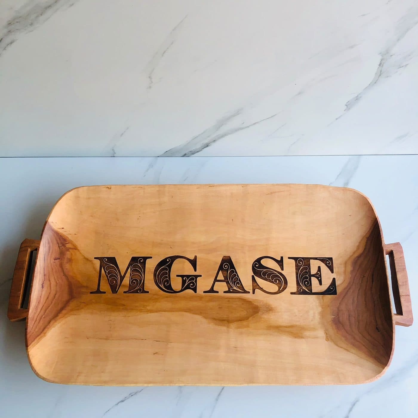 A hand-carved isithebe tray personalised with the Mgase family name